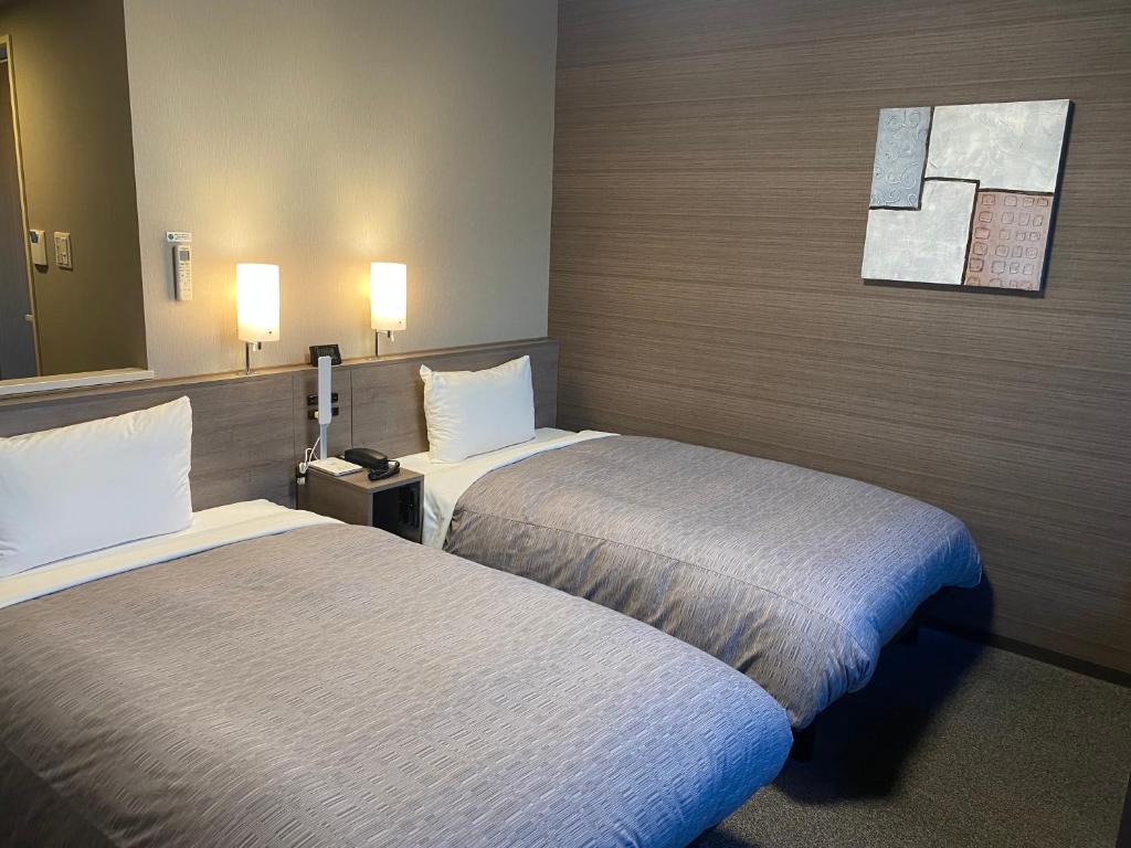 Postel nebo postele na pokoji v ubytování Hotel Route-Inn Ichihara