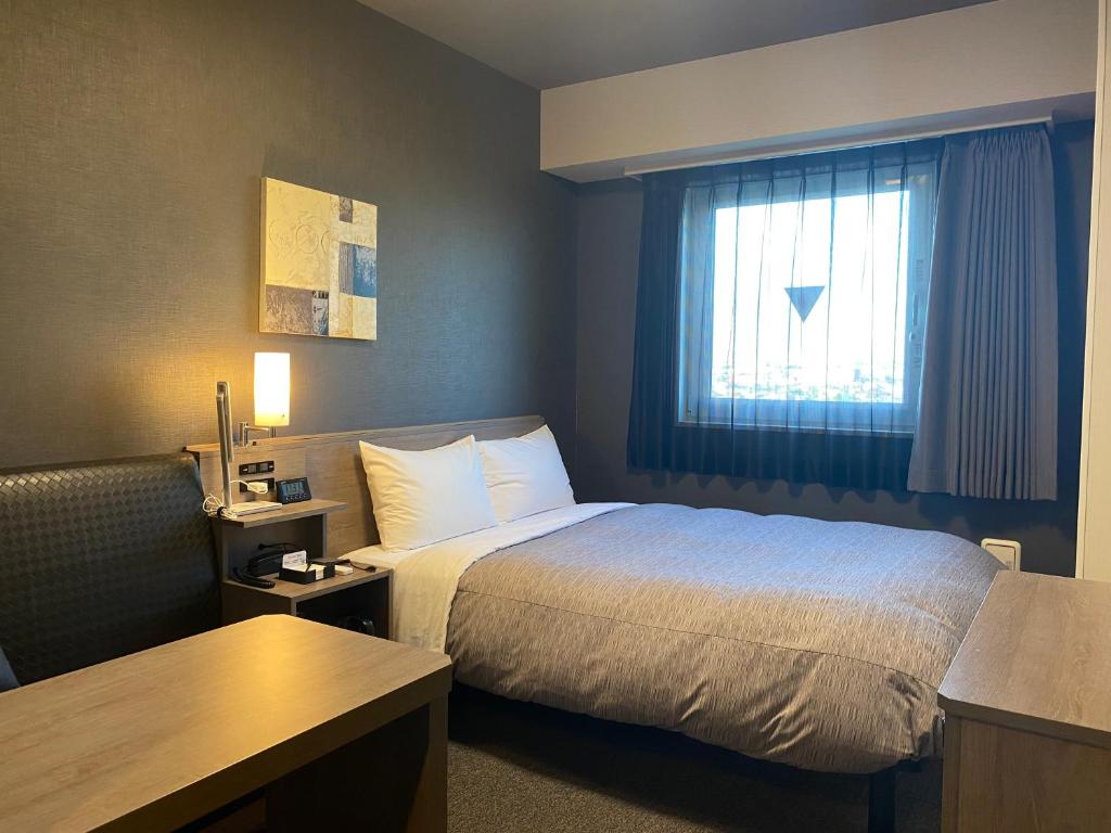 Postel nebo postele na pokoji v ubytování Hotel Route-Inn Ichihara