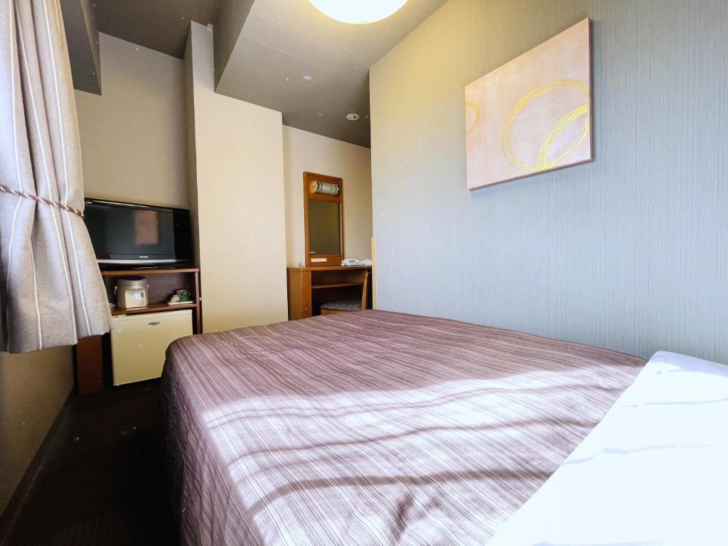 Postel nebo postele na pokoji v ubytování Hotel Route-Inn Honjo Ekiminami