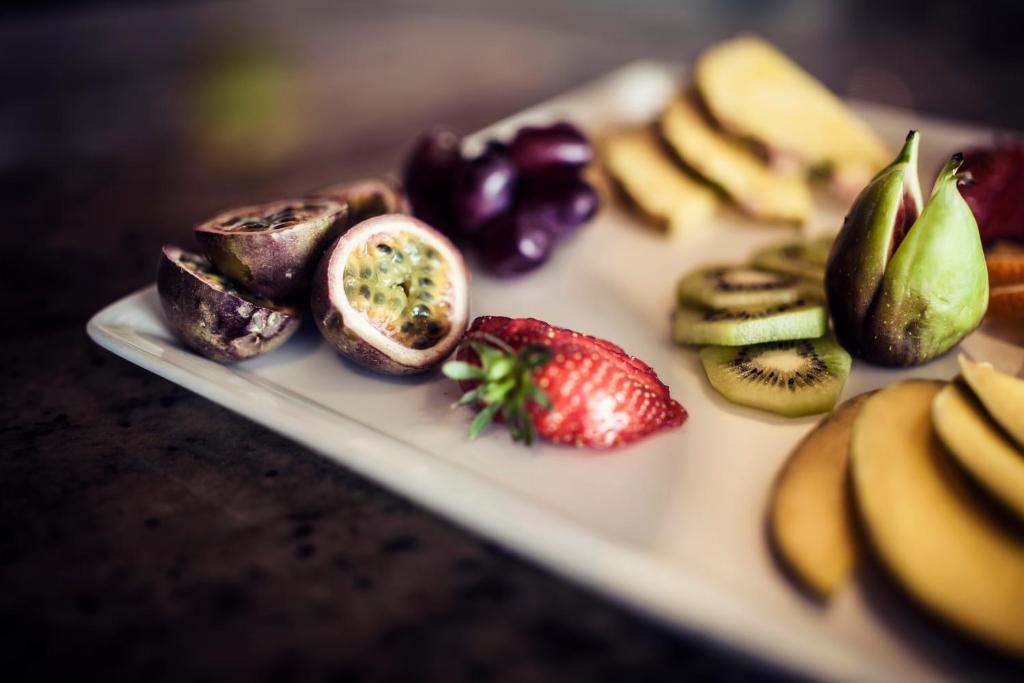 a plate of fruit and vegetables on a table at Carlton George Hotel in Glasgow
