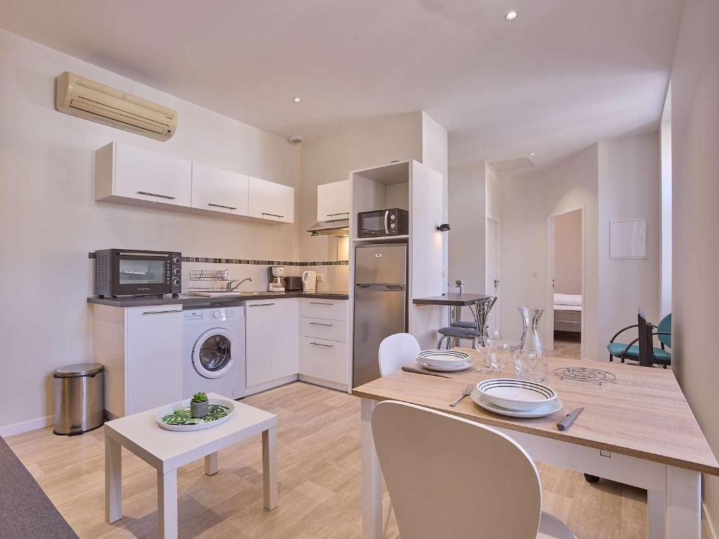 a kitchen with a table and a dining room at Appartement 2 pers avec Parking et Wifi à Barbotan - FR-1-841-13 in Barbotan-les-Thermes