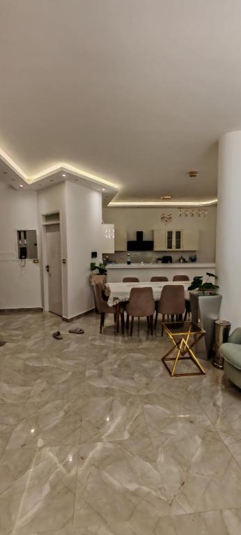 a large living room with a piano and chairs at فيلا بجوار سينزو مول in Hurghada