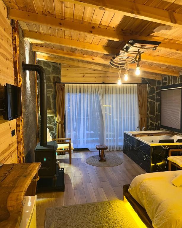 a bedroom with a wood stove in a room at Perla garden suit in Çamlıhemşin