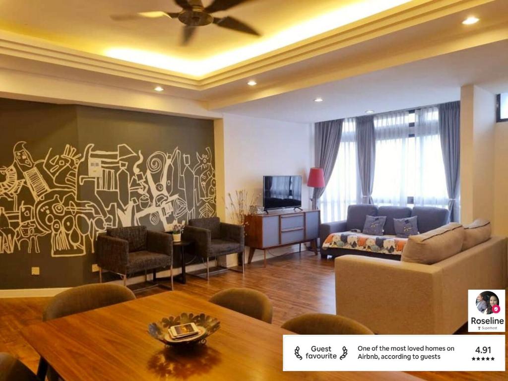 a living room with a painting on the wall at Fahrenheit 88 Suites Bukit Bintang by Roseline 2R in Kuala Lumpur