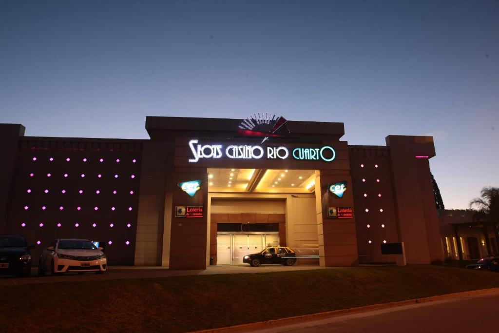 a car dealership with a sign that reads you and no one at Howard Johnson Rio Cuarto Hotel y Casino in Río Cuarto