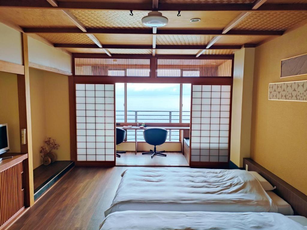 Postel nebo postele na pokoji v ubytování Hokkawa Onsen Hotel