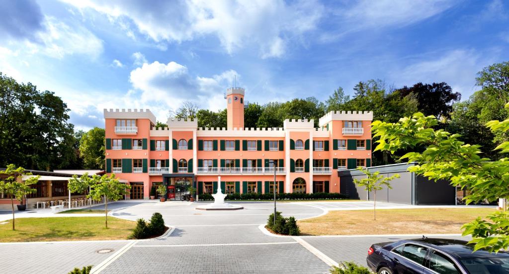 a building with a tower on top of it at Kim Schlosshotel im Park in Dresden
