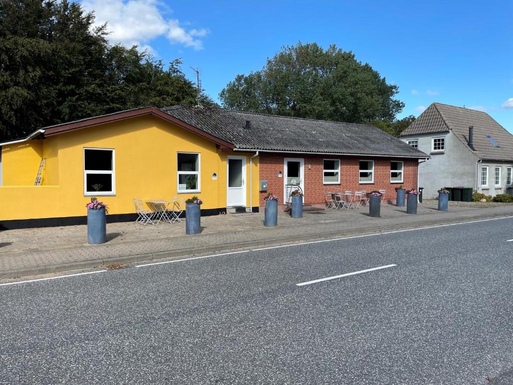 a yellow and red building on the side of a street at Stay in Brøns in Skærbæk