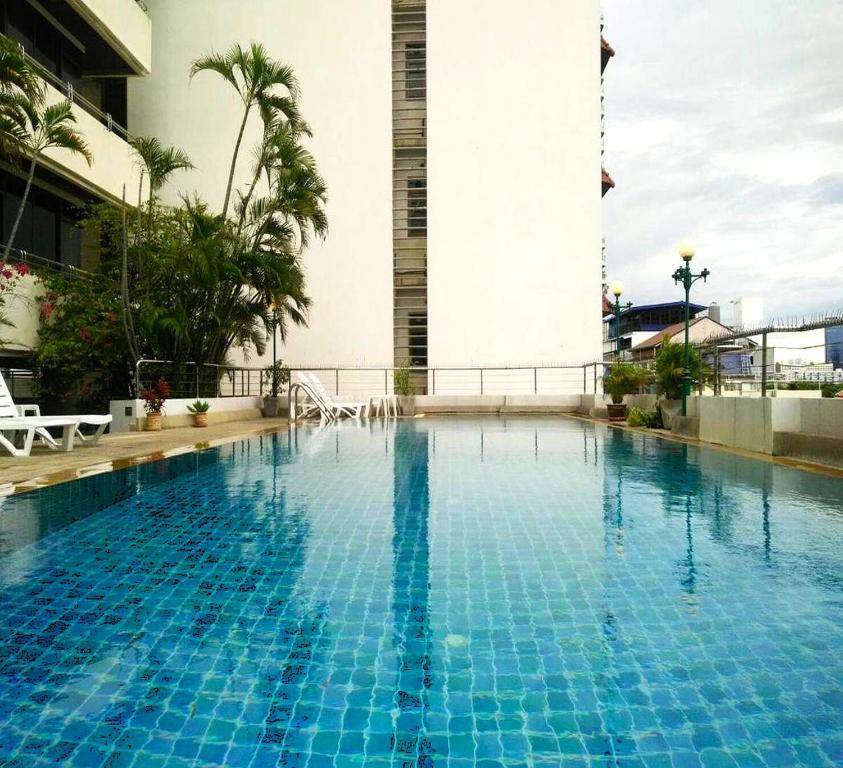 a large blue swimming pool in a hotel at ATVR Juldis Tower Pratunam in Bangkok