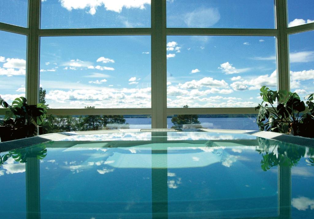 a large swimming pool with a large window at Hotell Wilhelmina in Vilhelmina