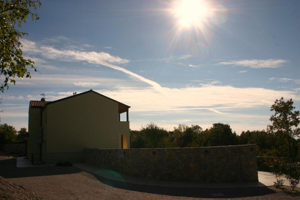 a building with the sun in the sky at Agriturismo Gradec in Aurisina
