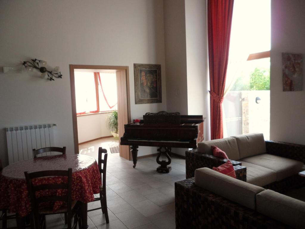 a living room with a couch and a piano at Agriturismo Gradec in Aurisina