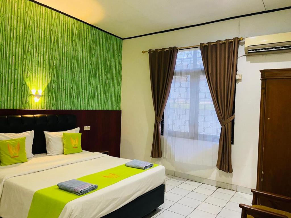Postel nebo postele na pokoji v ubytování Hotel Huswah Airport