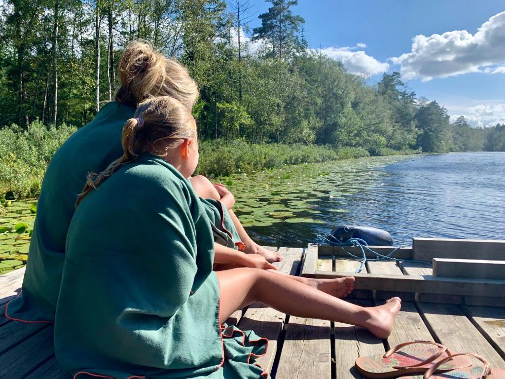 two women sitting on a boat on the water at Boafall Lodge in Jämshög