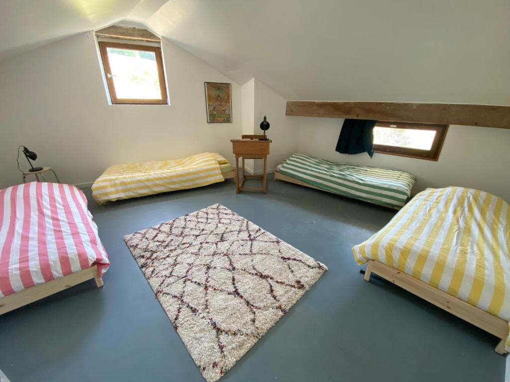 a room with two beds and a table in a room at Clos Sauvage in Leynes