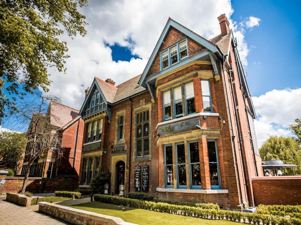 a large brick building with windows on a street at d'Parys in Bedford