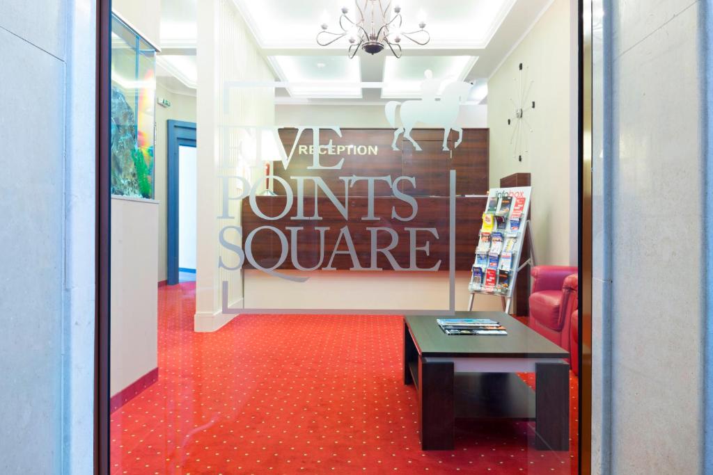 a waiting room with a red floor and a table at Five Points Square - City Center in Belgrade