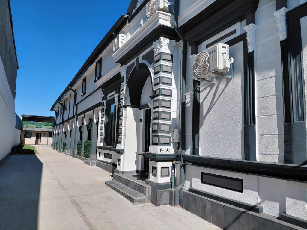 a white building with an archway on a street at Casa Carina in Brăila