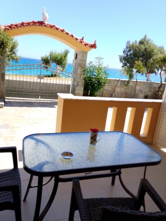a table on a patio with a view of the ocean at beach mourteri Evia in Mourteri