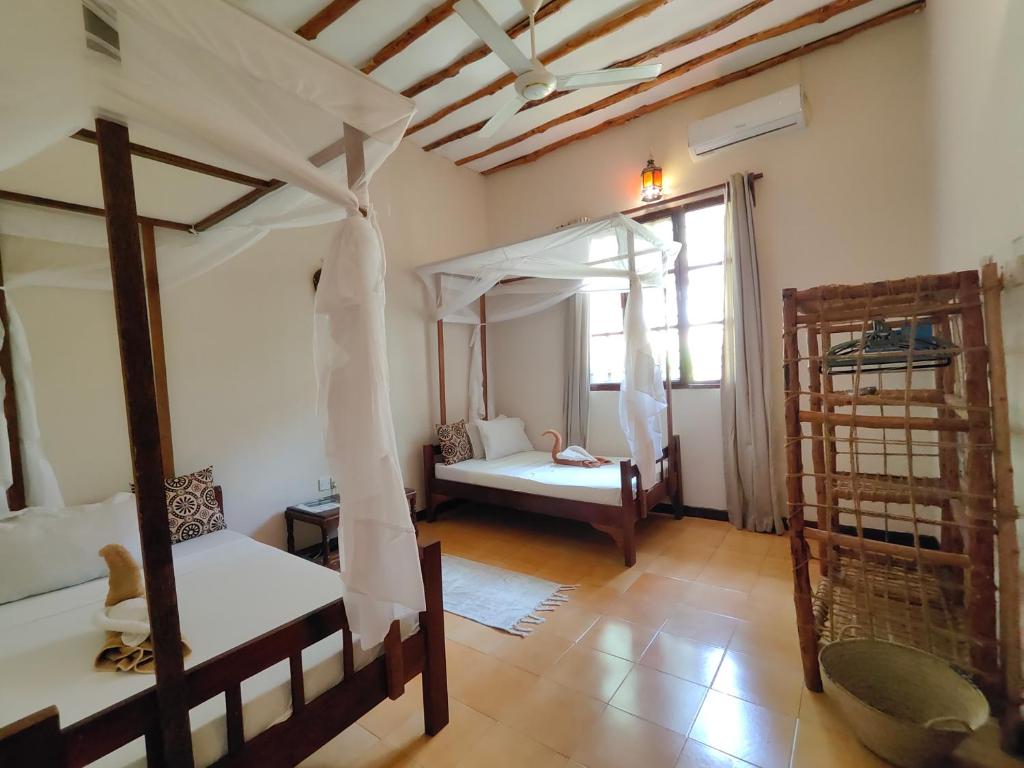 Postel nebo postele na pokoji v ubytování Hakuna Matata Villa