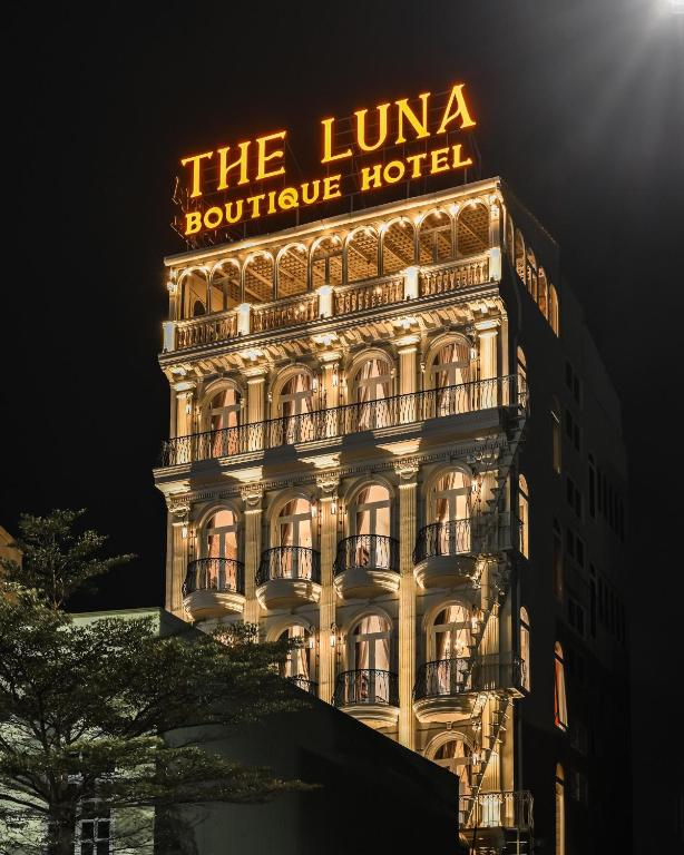 a lit up building with a hotel sign on it at The Luna Boutique Hotel in Quy Nhon