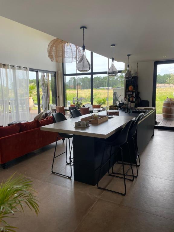 a living room with a large table and chairs at Villa 7 in Martillac