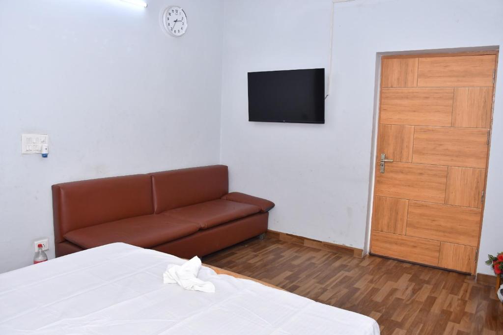 a living room with a couch and a television at The Farmstay in Jāmb