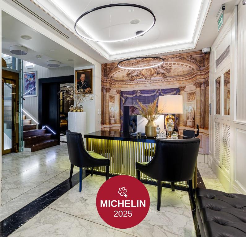 a lobby of a luxury hotel with a table and chairs at Hotel Teatro Boutique Old Town - Destigo Hotels in Warsaw