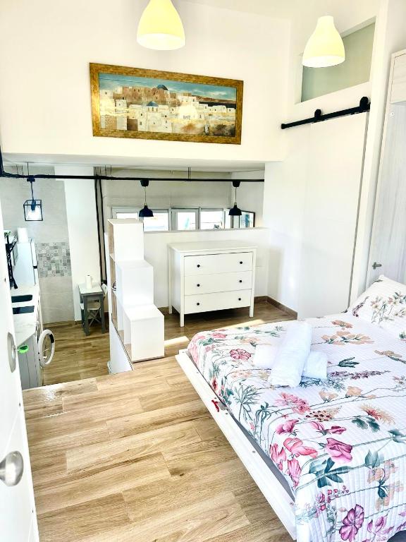 a bedroom with a bed and a dresser at Loft A Mariña Lucense in San Ciprián