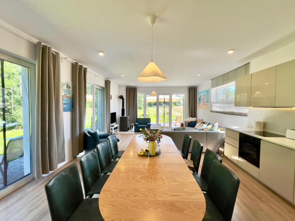 a dining room with a long table and chairs at Mazury Lake House Sailing & Nature in Dobrzyki