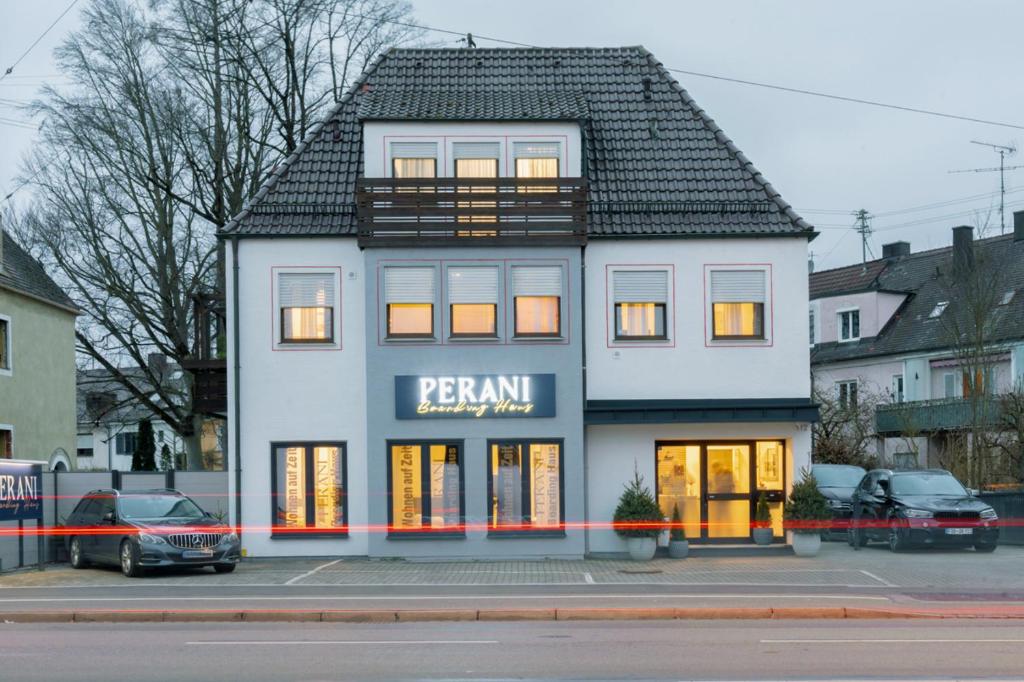 a large white building with a black roof at Boardinghaus Perani in Augsburg