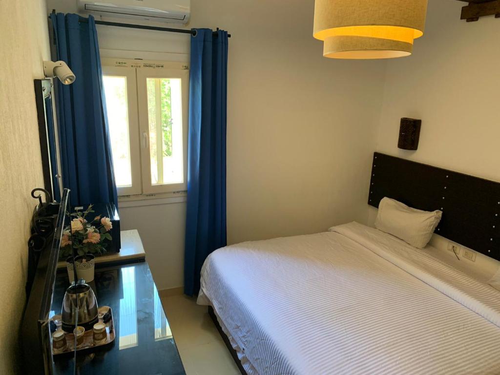 Postel nebo postele na pokoji v ubytování Ios Hotel & Village