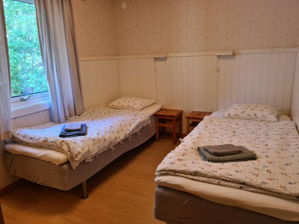 Postel nebo postele na pokoji v ubytování Gärdsholmens Skärgårdshemman "Boken"