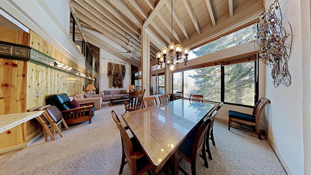 a dining room with a large table and chairs at Comfortable 4 Bedroom Condo in Mammoth Lakes