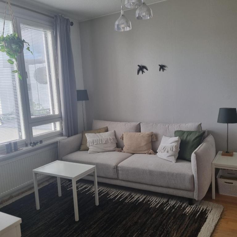 a living room with a couch and a table at Harju Rally with sauna in Jyväskylä