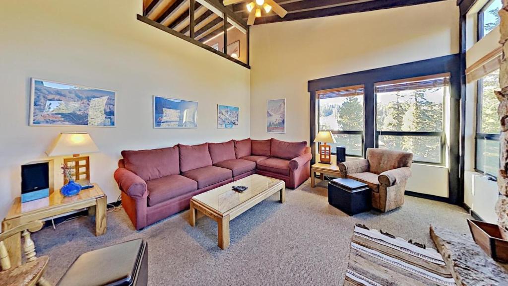 a living room with a couch and a tv at Beautiful 4 Bed Condo with Top Of The Hill Views! in Mammoth Lakes