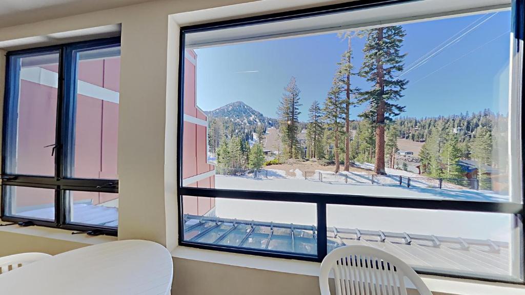 a room with a large window with a mountain view at Beautiful 2 BR Condo with Mountain View! in Mammoth Lakes