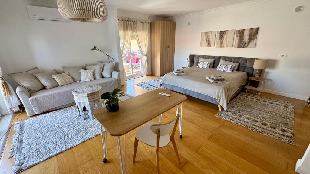 a living room with a couch and a table at 2 bedrooms with swimming pool Nomad Dreams N 7 in Cascais