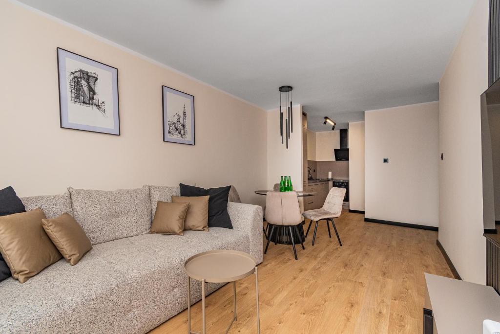 a living room with a couch and a table at Summer5 by Grand Apartments in Gdańsk