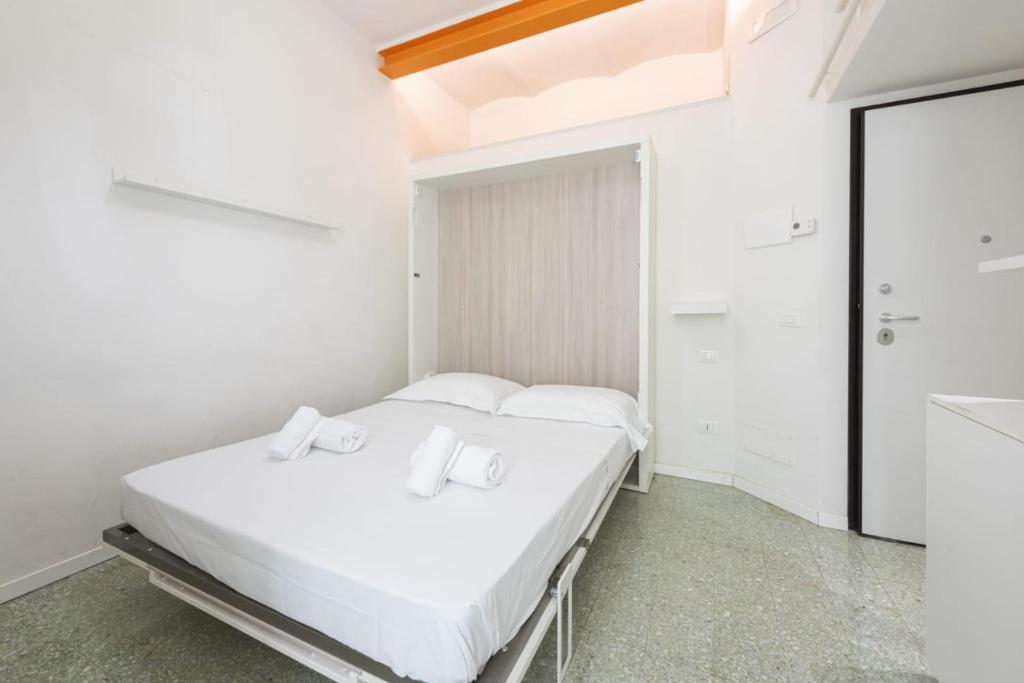 two beds in a room with white walls at Il Nido di Marta - Nido Verde in Florence