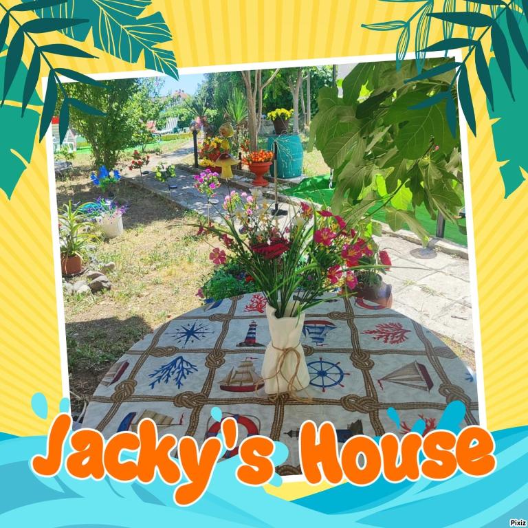 a table with a vase of flowers on it at Jacky's House in Chernomorets