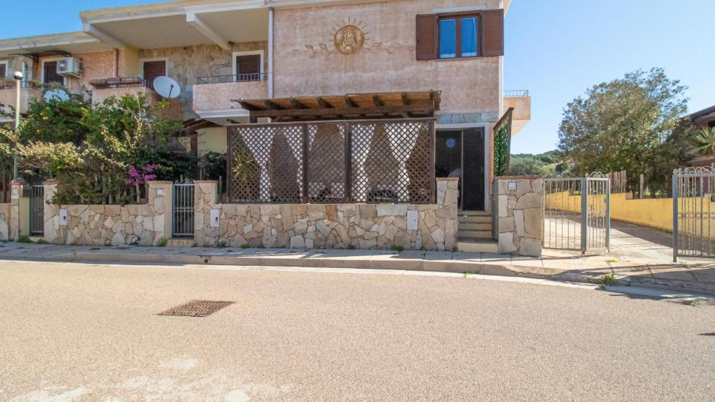 a fence in front of a building with a gate at Domus Peppi in Villasimius