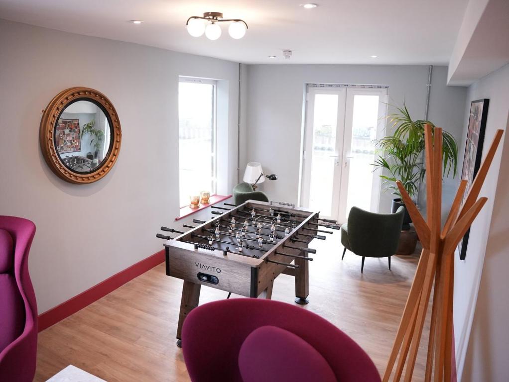 a living room with a foos ball on a table at Spacious Cardiff Apartment for Large Groups! in Cardiff
