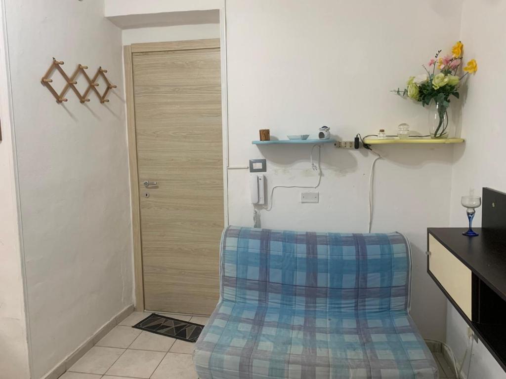 a kitchen with a chair in front of a door at La Stanza del Mare in Calasetta