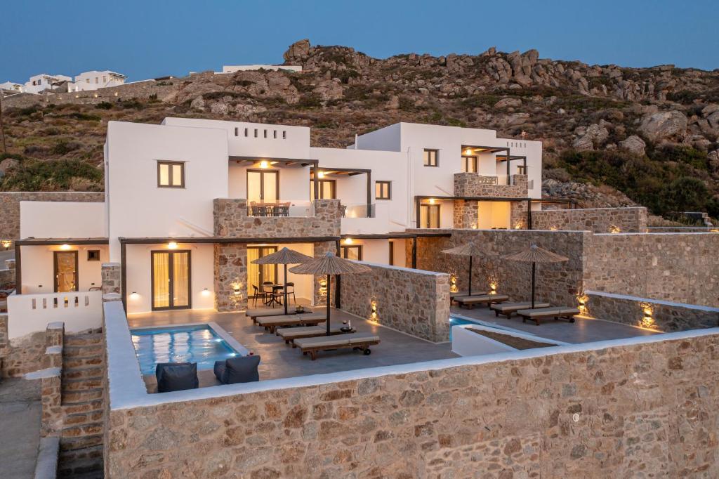 a house on a hill with a swimming pool at Lithia Exclusive Villas & Suites in Plaka