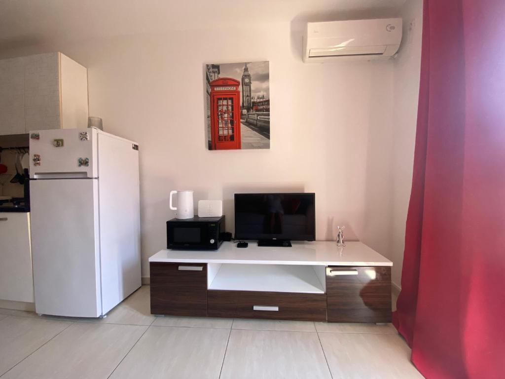 a kitchen with a white refrigerator and a desk at Friends-2 in Risan