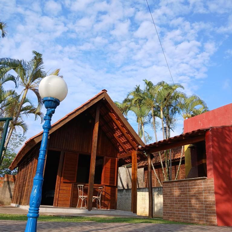 a house with a light pole in front of it at CLUBE e HOTEL ARIRANG in Itu