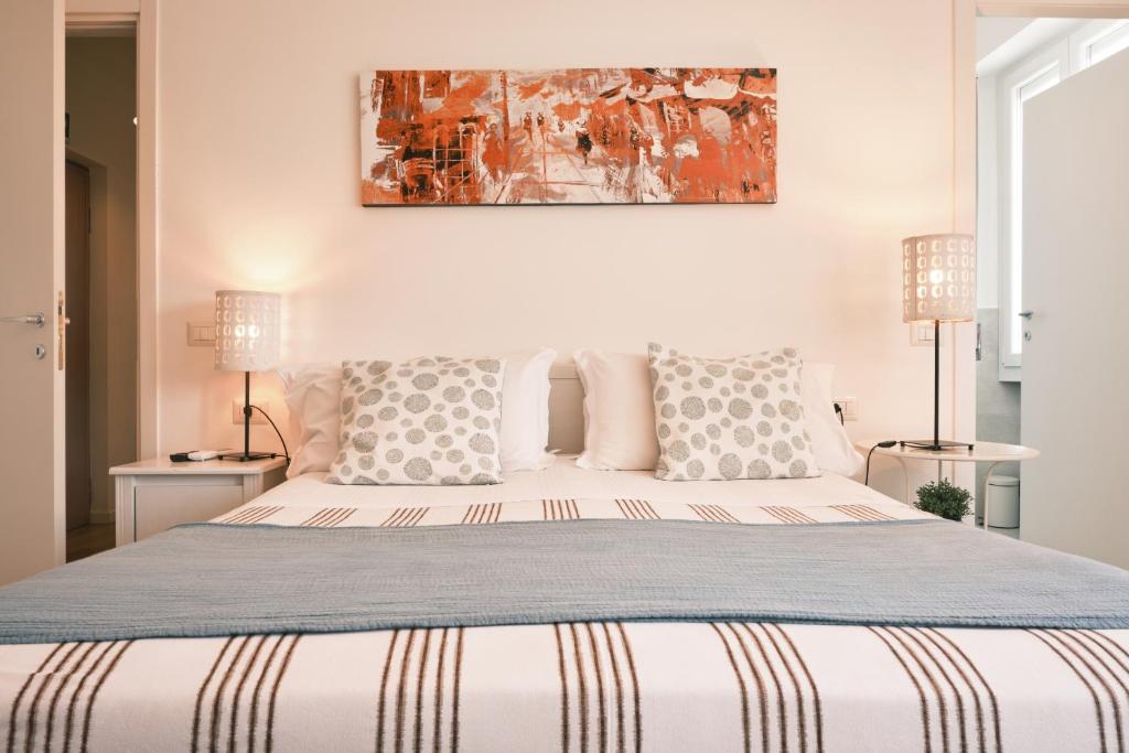 a bedroom with a large bed with two lamps at Milano 71 in Milan