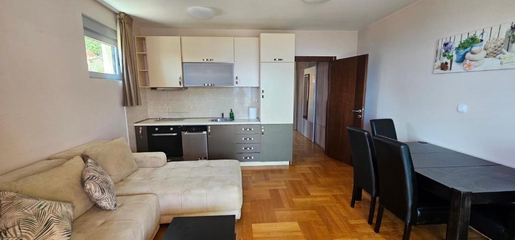 a living room with a couch and a table and a kitchen at The Old Town Terrace Apartments in Budva