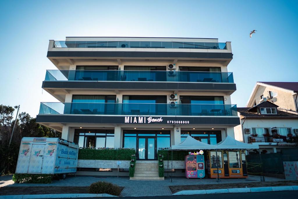 a tall building with a restaurant in front of it at miami costinesti in Costinesti